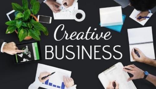 An image with a top view of a business meeting and the text Creative Business in the center - How to start a part-time business that works - Image
