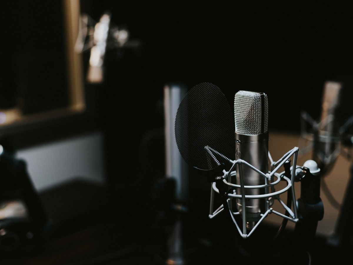 Image of a microphone with a dark studio background - Ideas for engaging video interviews on YouTube - Image