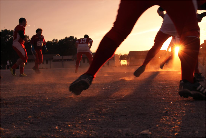 Soccer team playing a game at sunset