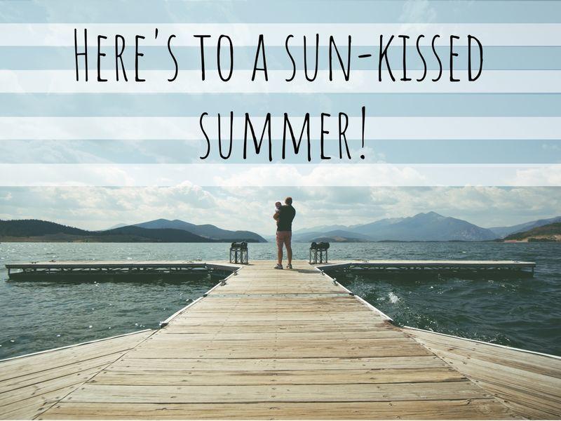 View of a man with a child in his arms standing on the pier and looking into the distance with 'Here's to a sun-kissed summer!' as a title - Nautical stripes will evolve in 2019 - Image