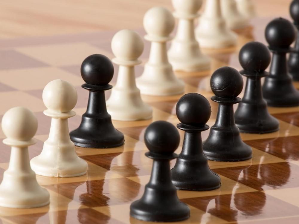 Pawns on a chessboard - 70 creative ways to boost employee morale - Image