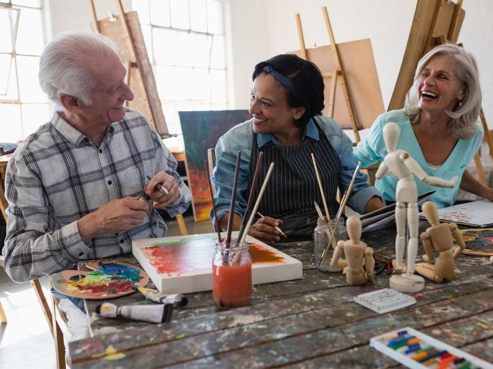 Seniors communicate and practice painting - 70 creative ways to boost employee morale - Image