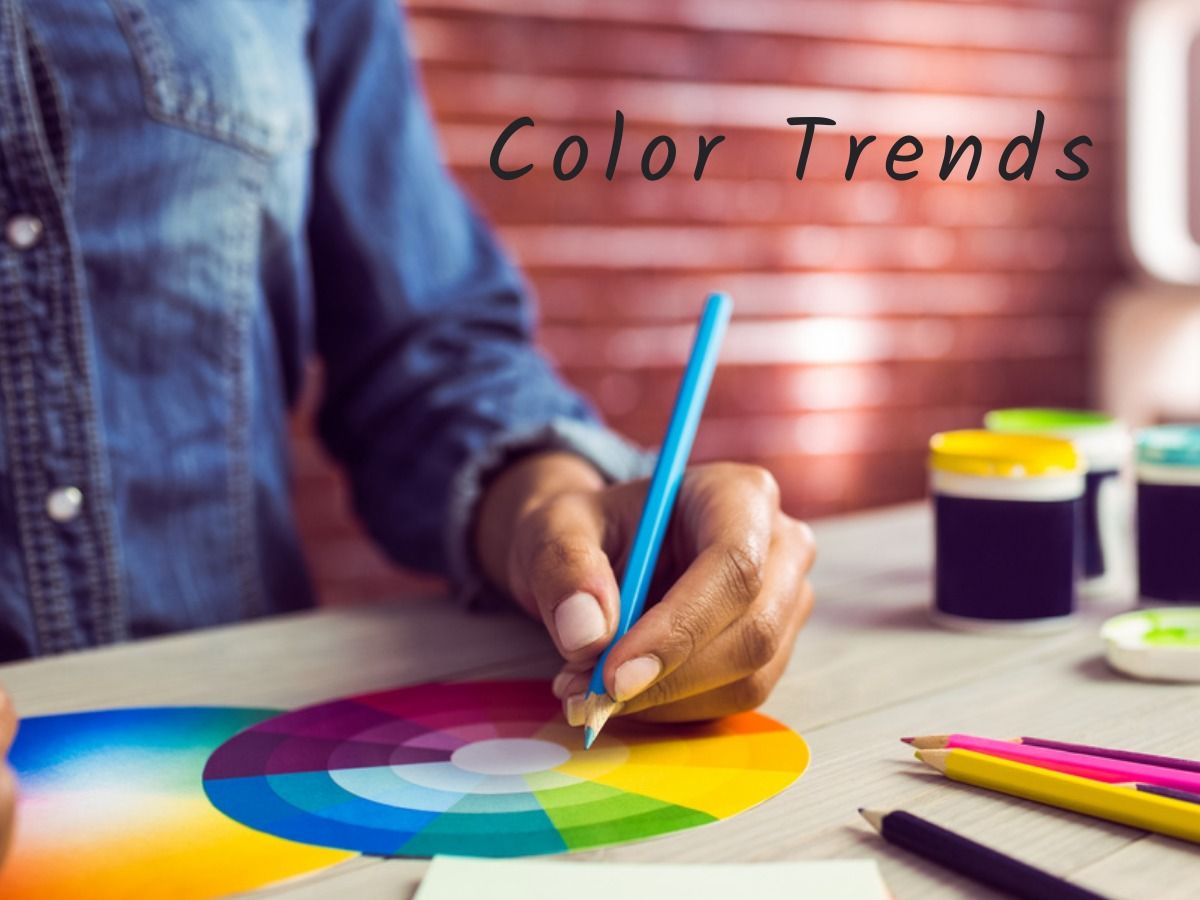 Person with blue pencil and colour wheel - The biggest trends in graphic design for 2021 - Image