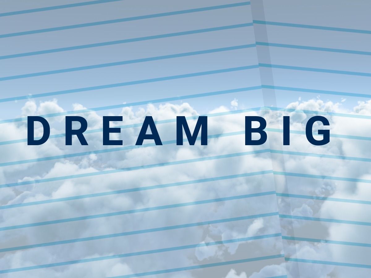 Wolkenfoto mit den Worten „Dream Big“ vor einem Notizbuchhintergrund