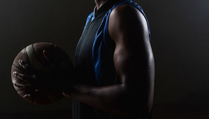 Photo of a male basketball player holding a ball - Free online photo enhancement with Design Wizard - Image