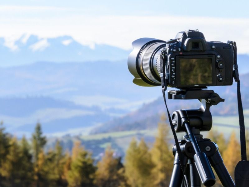 The camera on a tripod is pointed towards the forest - How to make a YouTube video in 5 simple steps - Image