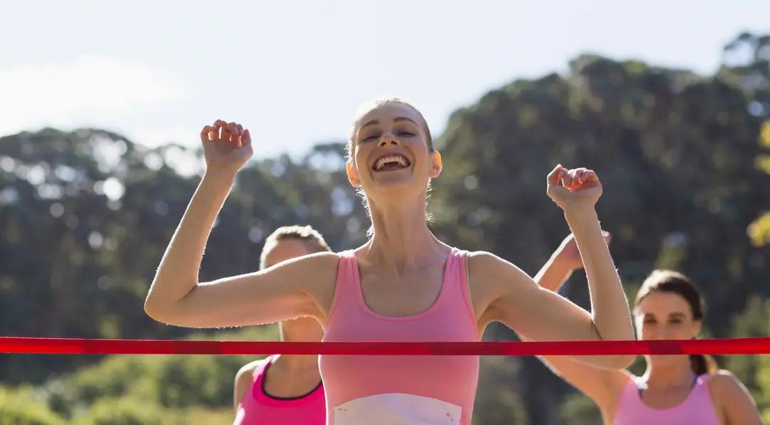 Cheerful winner athlete crossing finish line - Image