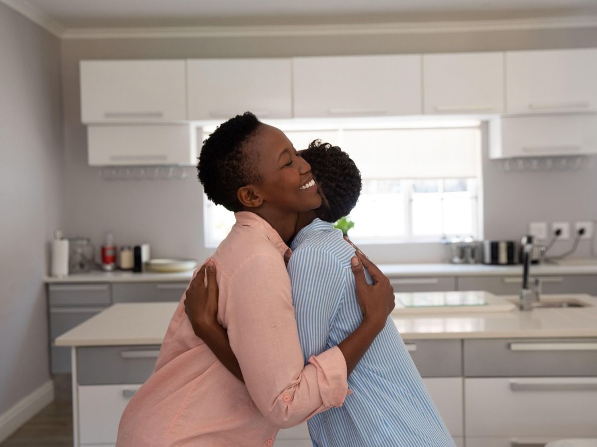 Couple hugging in the kitchen20 proven real estate marketing ideas to help attract qualified buyers - Image