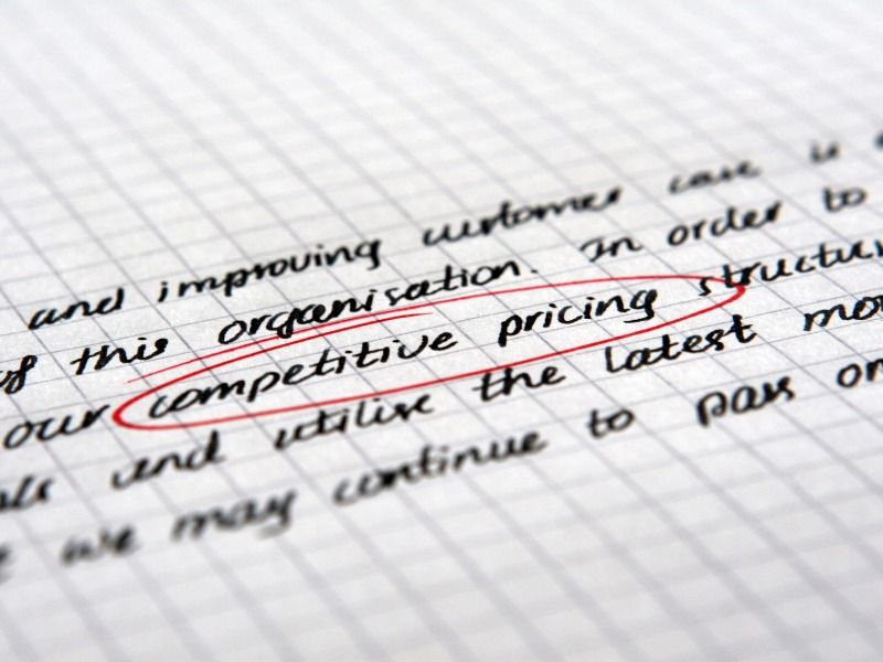 The words Competitive Prices, handwritten on graph paper, are circled in red - The best social media marketing tips for starting and growing your business - Image