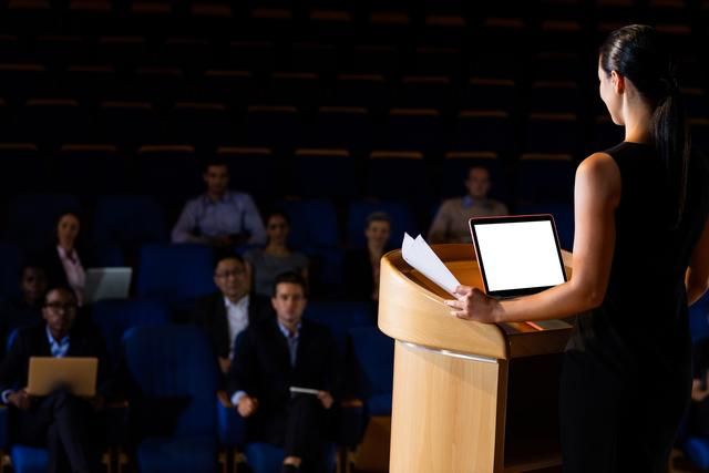 Woman giving a speech - The 100 best event marketing ideas of 2019 - Image