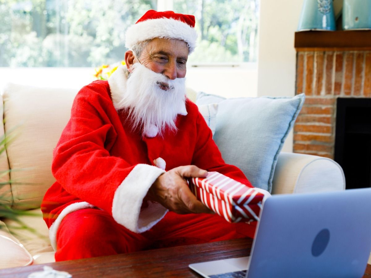Image of Santa giving a gift via laptop - Essential video marketing tips for beginners in 2021 - Image