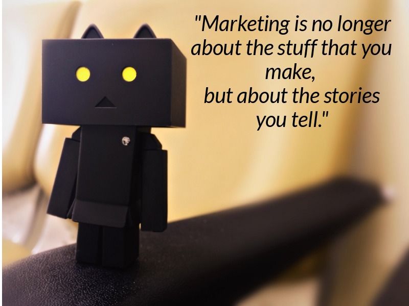 A quote about marketing and storytelling over a photo of a black cardboard Revoltech Danbo figure with cat ears - Learn about the power of visual storytelling in marketing - Image