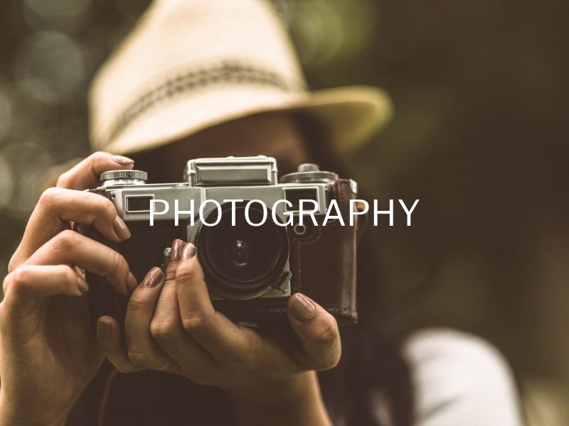 Female photographer with camera close up - 36 creative YouTube banner ideas and examples to boost your inspiration - Image