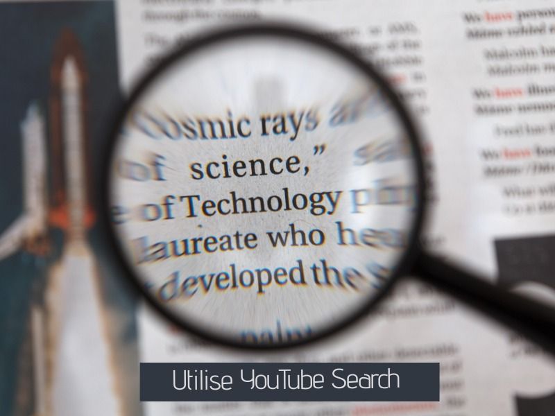 Magnifying glass on newspaper - Effective YouTube marketing tips - Image