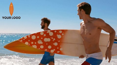 two surfers run on the beach